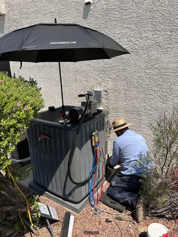 HVAC technician performing outdoor AC maintenance in Hinesville